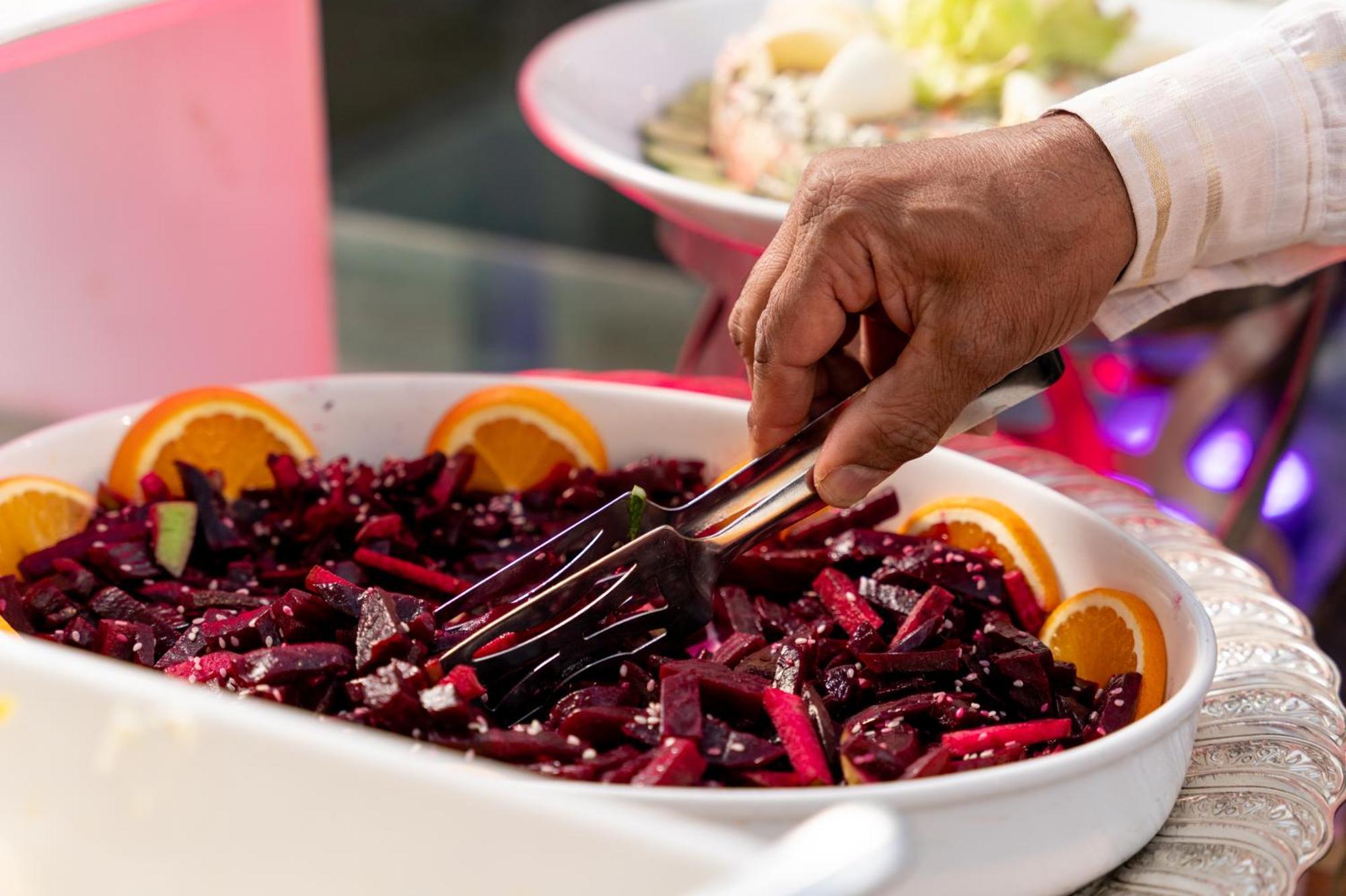 Sheraton Dammam Hotel & Convention Centre Екстер'єр фото A hand using a buffet server to serve food